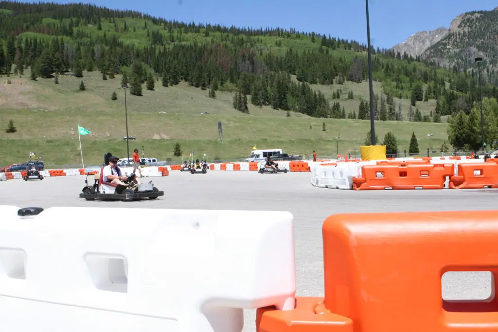 people go-karting through track barriers