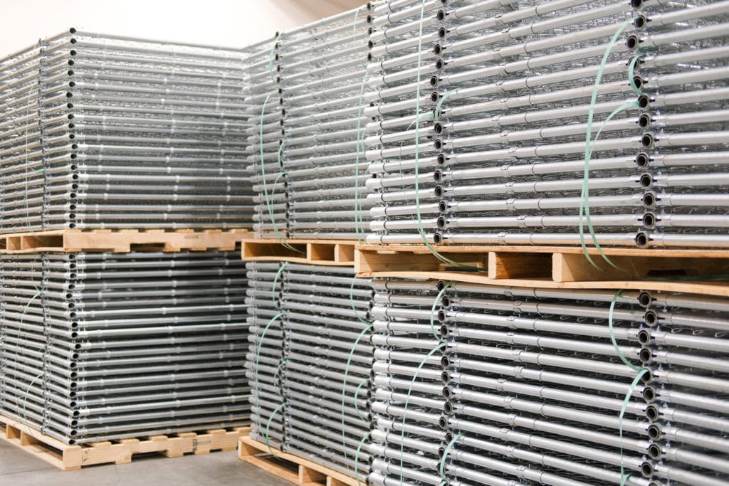 Palletized steel fence panels stacked on one another