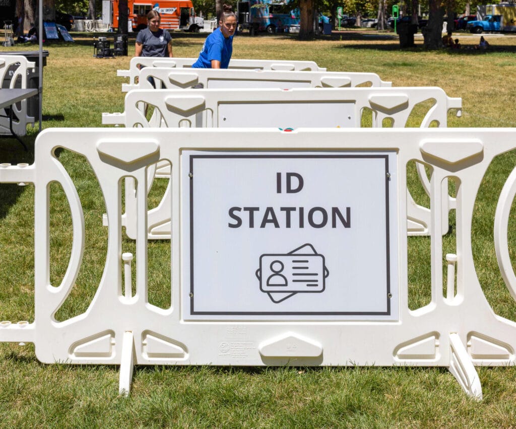 White barricade with signage that reads: ID Station
