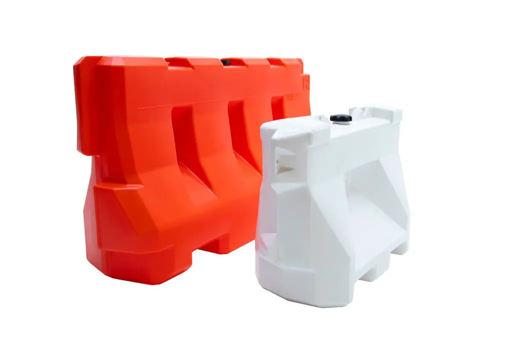 OTW 42" LCD plastic jersey barricade in safety orange next to OTW 32" LCD plastic jersey barrier in white with white backdrop. Photo demonstrates height difference between the two products.