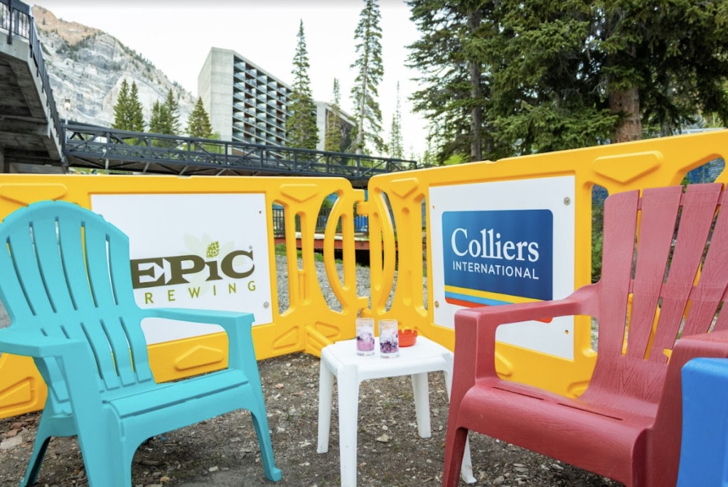 Yellow Billboard Barricades with Custom Signage behind brightly colored plastic chairs