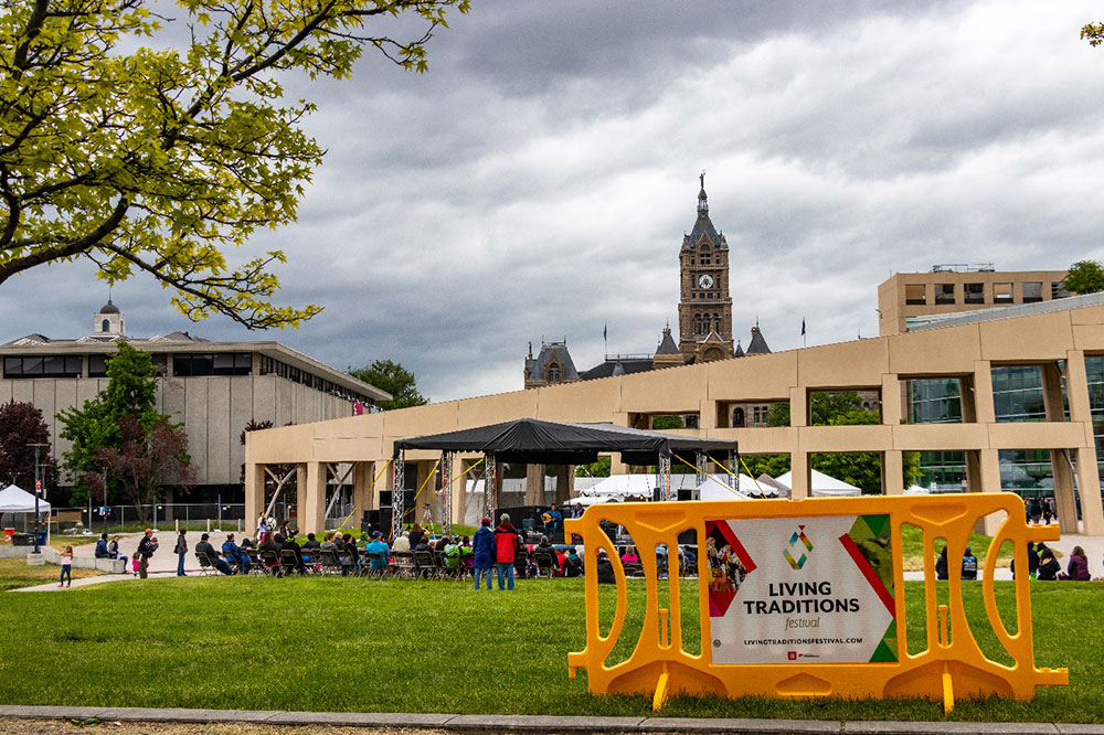 yellow crowd barrier with branded sign in use at living traditions festival slc 2019