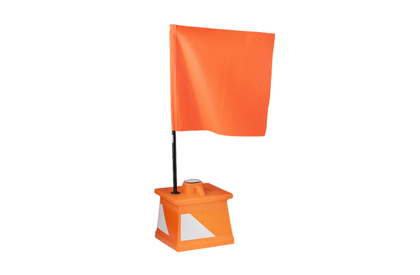 OTW orange airport barricade flag "waves" atop a small airport delineator barricade