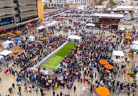 Aerial view of the Doxie Derby event with OTW Safety billboard barricades surrounding the race track for crowd control