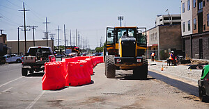OTW Safety jersey barricades forming pedestrian walkway at roadside construction site