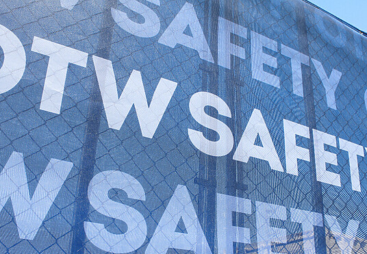 OTW Safety branded mesh fence scrim attached to barricade fence panels
