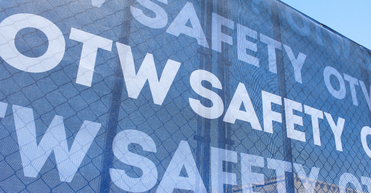 OTW Safety branded mesh fence scrim attached to barricade fence panels