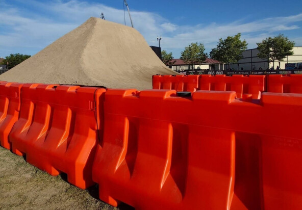 OTW Safety orange jersey shaped 42 inch LCD barricades at X Games SLC 2025 surrounding the dirt course for the BMX and Moto X events.