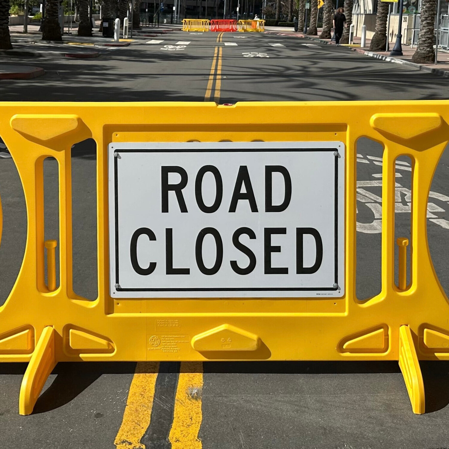 a yellow OTW Safety billboard barricade with a sign reading 