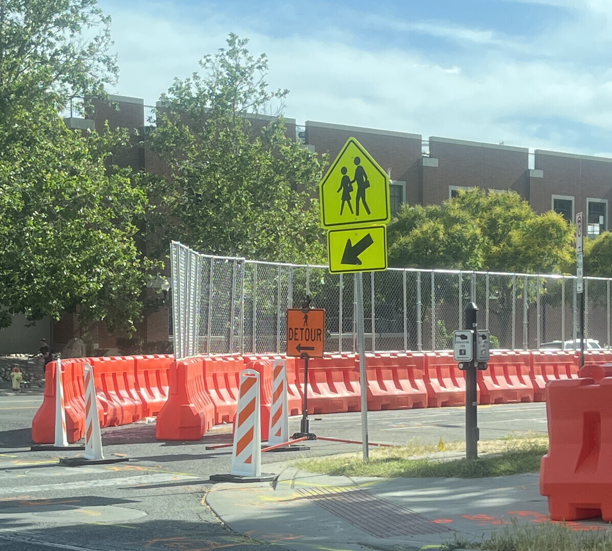 OTW Safety 42x72 orange plastic barricade creating a safe pedestrian walkway next to construction site.