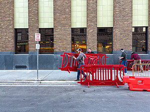 Using OTW Safety barricades for pedestrians at the store entrance during peak shopping times for crowd control safety measures.