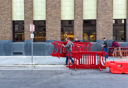 Using OTW Safety barricades for pedestrians at the store entrance during peak shopping times for crowd control safety measures.