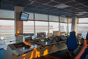 Dispatcher background. The workplace of the traffic manager at the airport at the tower. Chair, table, monitors, screens, and equipment. Air traffic controller work