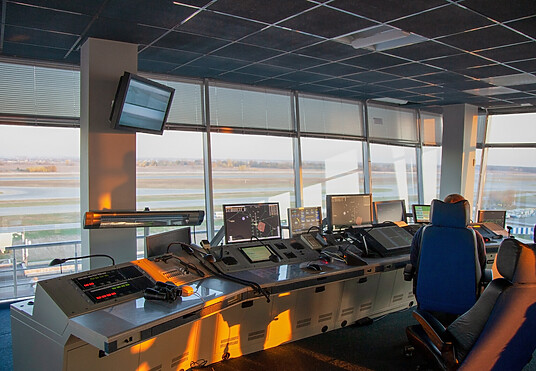 Dispatcher background. The workplace of the traffic manager at the airport at the tower. Chair, table, monitors, screens, and equipment. Air traffic controller work