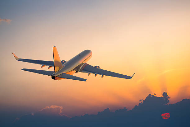 Commercial aircraft taking off at sunset, representing airport safety operations and proper barricade placement on active airfields.