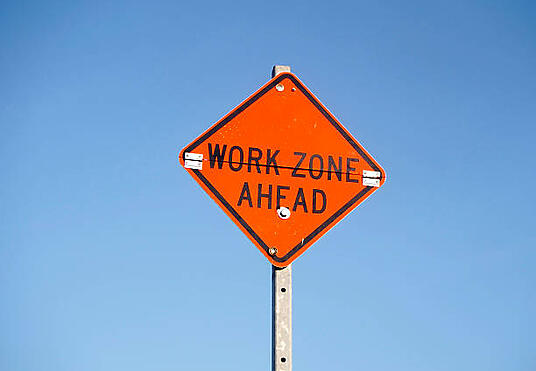 Construction work zone with traffic barricades and safety equipment highlighting common mistakes that can cause project delays